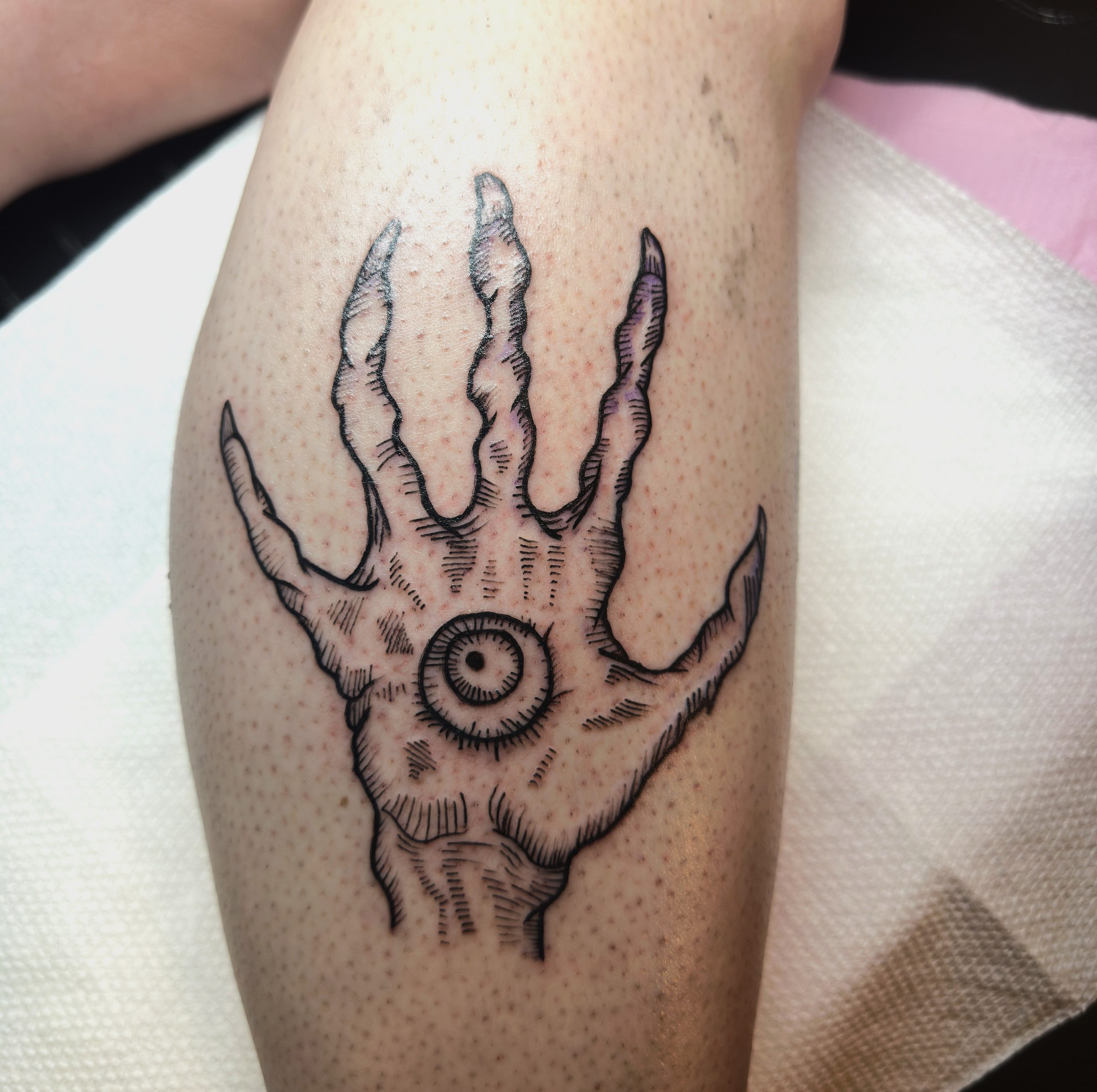 Goth style tattoo on the calve of the hand and eye of Vecna. A D&D style tattoo