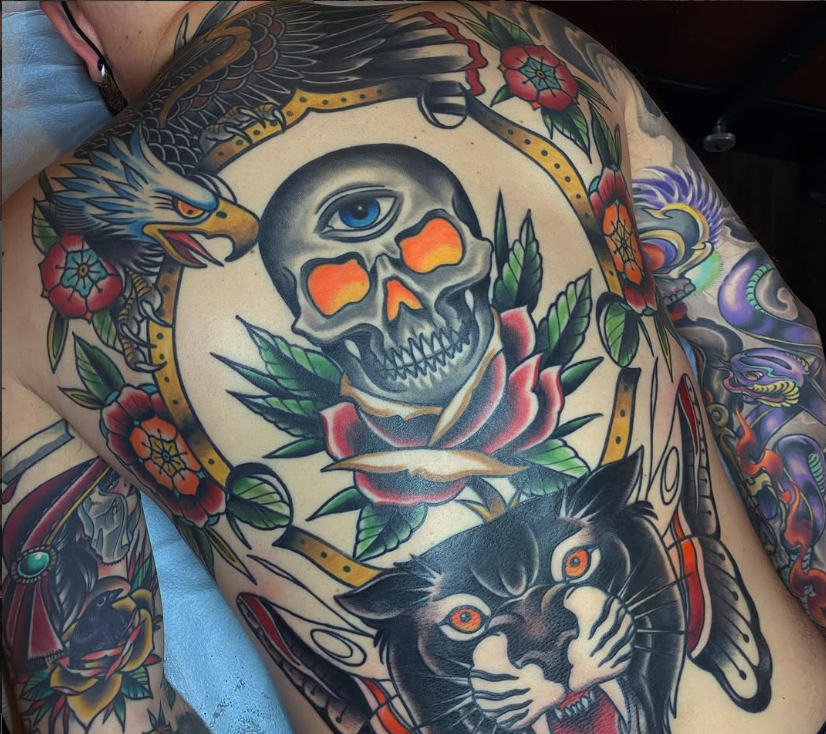 Traditional back piece tattoo with panther skull and roses