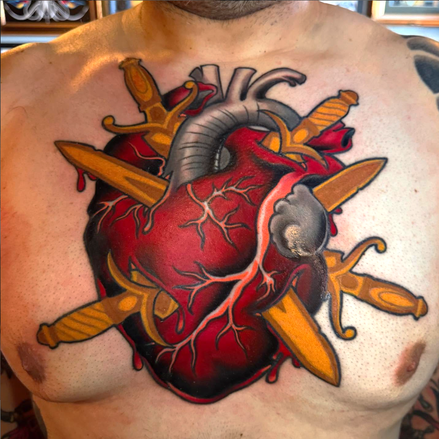 Neo traditional heart tattoo with gold daggers at bomber crew tattoo